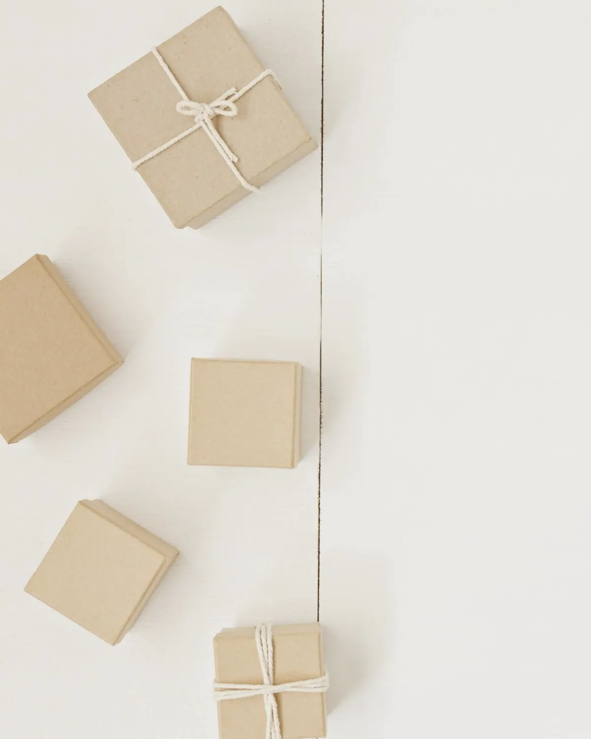 Small kraft-paper gift boxes tied with string