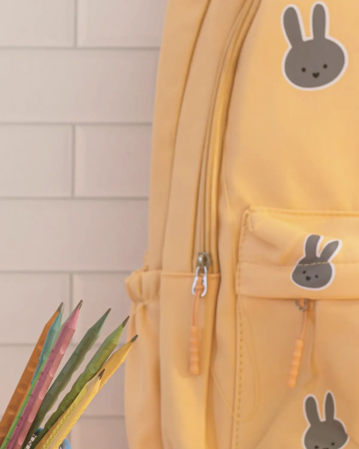 Yellow children's school backpack with rabbit patches