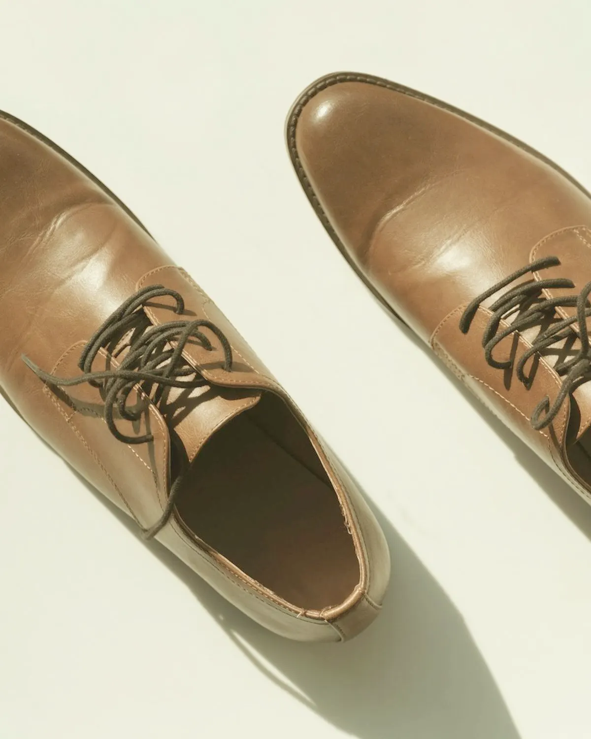 Pair of brown leather lace-up shoes viewed from above